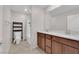 Well-lit bathroom with double vanity, tile flooring, and a shower with a white shower curtain at 5503 Jinan St, Las Vegas, NV 89148