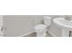 Neutral toned powder bathroom features a toilet and pedestal sink with modern faucet at 5503 Jinan St, Las Vegas, NV 89148