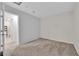A bedroom with gray walls and tan carpet with an open doorway at 5503 Jinan St, Las Vegas, NV 89148