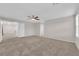 Spacious carpeted bedroom with ceiling fan and neutral walls at 5503 Jinan St, Las Vegas, NV 89148