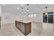 Open-concept kitchen island featuring a sink, dishwasher, and bar seating with decorative lighting fixtures at 5503 Jinan St, Las Vegas, NV 89148