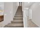 Carpeted staircase with white railings leads to the upper level of the home at 5503 Jinan St, Las Vegas, NV 89148