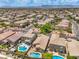 A vast aerial shot showcasing a suburban community with pools and well maintained landscaping at 5528 Stone Lagoon St, North Las Vegas, NV 89031