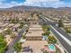 A high altitude shot over houses with swimming pools in suburban neighborhood at 5528 Stone Lagoon St, North Las Vegas, NV 89031