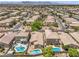 Birds eye view of a suburban neighborhood with houses and pools at 5528 Stone Lagoon St, North Las Vegas, NV 89031