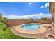 Backyard featuring a pool, green grass, and rock landscaping, perfect for a relaxing getaway at 5528 Stone Lagoon St, North Las Vegas, NV 89031