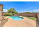 Backyard featuring a relaxing pool with rock landscaping and well manicured lawn and hedges at 5528 Stone Lagoon St, North Las Vegas, NV 89031
