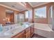 Bright bathroom with dual sink vanity, soaking tub and walk-in shower at 5528 Stone Lagoon St, North Las Vegas, NV 89031
