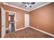 This bedroom features plush carpeting, neutral paint, a ceiling fan, and white doors and trim at 5528 Stone Lagoon St, North Las Vegas, NV 89031