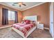 Cozy bedroom showcasing a bed with decorative pillows, neutral walls, and a ceiling fan at 5528 Stone Lagoon St, North Las Vegas, NV 89031