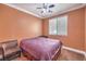 Bedroom featuring a ceiling fan and a window with natural light and brown carpet at 5528 Stone Lagoon St, North Las Vegas, NV 89031