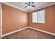 Cozy bedroom with carpet, window, and ceiling fan at 5528 Stone Lagoon St, North Las Vegas, NV 89031