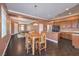 Charming dining room with wood table, flowing into the kitchen and game room areas at 5528 Stone Lagoon St, North Las Vegas, NV 89031