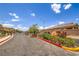 Well-maintained community entrance featuring stone signage and lush landscaping at 5528 Stone Lagoon St, North Las Vegas, NV 89031