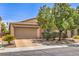 Inviting single-story home featuring a two-car garage and low-maintenance desert landscaping at 5528 Stone Lagoon St, North Las Vegas, NV 89031