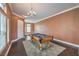 Spacious game room with a pool table, chandelier lighting, wood-look floors, and neutral paint at 5528 Stone Lagoon St, North Las Vegas, NV 89031