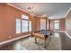 Spacious game room featuring a pool table, wood-look floors, neutral paint, and multiple windows at 5528 Stone Lagoon St, North Las Vegas, NV 89031