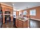 Open kitchen with granite countertops, stainless appliances, and dark wood flooring at 5528 Stone Lagoon St, North Las Vegas, NV 89031