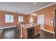Open kitchen with granite countertops, stainless steel appliances, and dark wood flooring at 5528 Stone Lagoon St, North Las Vegas, NV 89031