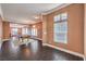 Bright, open living space with dark wood floors, a game room, and views into dining and living areas at 5528 Stone Lagoon St, North Las Vegas, NV 89031