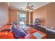Cozy living room with a large sectional sofa, a ceiling fan and a view of the backyard at 5528 Stone Lagoon St, North Las Vegas, NV 89031