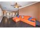 Open living room features wood flooring, ceiling fan, and seamless access to the dining area at 5528 Stone Lagoon St, North Las Vegas, NV 89031