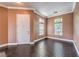 Inviting room showcasing dark wood floors, neutral walls, and multiple windows that provide ample natural light at 5528 Stone Lagoon St, North Las Vegas, NV 89031