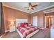 Bedroom with ceiling fan, carpeted flooring and a view of the hallway at 5528 Stone Lagoon St, North Las Vegas, NV 89031