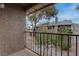 Apartment balcony with metal railing overlooking exterior greenery and an adjacent building at 573 Sellers Pl, Henderson, NV 89011