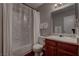 Neutral bathroom features a shower and bath combination, vanity and storage at 573 Sellers Pl, Henderson, NV 89011