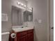 Bathroom featuring a single sink vanity with wooden cabinets and a mirrored medicine cabinet at 573 Sellers Pl, Henderson, NV 89011