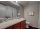 Cozy bathroom with wood cabinets, great lighting, and a neutral color palette at 573 Sellers Pl, Henderson, NV 89011