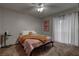 Cozy bedroom with carpet, ceiling fan, neutral paint, and window with light-filtering curtains at 573 Sellers Pl, Henderson, NV 89011