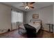 Bedroom features neutral walls, ceiling fan, window, and iron bed frame with side table at 573 Sellers Pl, Henderson, NV 89011