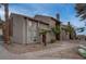 Inviting condo featuring a stucco exterior, desert landscaping, and a welcoming entrance at 573 Sellers Pl, Henderson, NV 89011