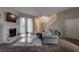 Bright living room featuring a fireplace, plush seating, and a staircase at 573 Sellers Pl, Henderson, NV 89011