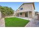 Backyard features green turf, a covered patio, and privacy block wall, ideal for outdoor activities at 5834 Autumn Harvest Ave, Las Vegas, NV 89142