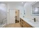Elegant bathroom boasting double vanity with marble counters, illuminated mirrors, and a walk-in shower at 5834 Autumn Harvest Ave, Las Vegas, NV 89142