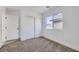 Well-lit bedroom with carpet, neutral walls, a window, and a closet with sliding doors at 5834 Autumn Harvest Ave, Las Vegas, NV 89142