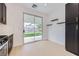 Eat-in kitchen area with black cabinets, stainless appliances, and a sliding door to backyard at 5834 Autumn Harvest Ave, Las Vegas, NV 89142