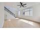 Open living area with hardwood floors, high ceilings, modern staircase, and lots of natural light at 5834 Autumn Harvest Ave, Las Vegas, NV 89142