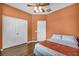 This bedroom features a ceiling fan, closet space, and hardwood flooring at 5992 Quintillion Ave, Las Vegas, NV 89122
