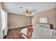 Bedroom with hardwood floors, ceiling fan, and ample natural light at 5992 Quintillion Ave, Las Vegas, NV 89122