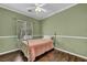 Cozy bedroom with hardwood floors, ceiling fan, and an abundance of natural light at 5992 Quintillion Ave, Las Vegas, NV 89122