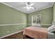 Bright bedroom with a full window offering natural light and a ceiling fan at 5992 Quintillion Ave, Las Vegas, NV 89122