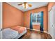 Cozy bedroom features hardwood flooring, ample natural light, and closet space at 5992 Quintillion Ave, Las Vegas, NV 89122