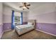 Cozy bedroom featuring natural light, carpet, and a ceiling fan for added comfort at 5992 Quintillion Ave, Las Vegas, NV 89122