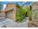 Inviting home exterior showcasing a neat front yard, a two-car garage, and a welcoming entrance at 5992 Quintillion Ave, Las Vegas, NV 89122