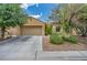 Charming single-story home featuring a well-manicured front yard and an attached two-car garage at 5992 Quintillion Ave, Las Vegas, NV 89122