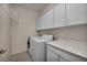 Functional laundry room with white cabinets, countertop, and appliances at 5992 Quintillion Ave, Las Vegas, NV 89122